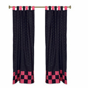 Black sari tab top curtains hung at a window