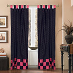 Black sari tab top curtains hung at a window