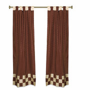 Brown sari tab top curtains hung at a window