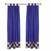 Blue sari tab top curtains hung at a window