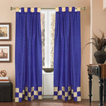 Blue sari tab top curtains hung at a window