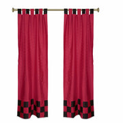 Red sari tab top curtains hung at a window