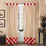 Gold sari tab top curtains hung at a window