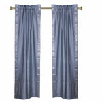 Silver sari rod pocket curtains hung at a window