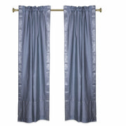 Silver sari rod pocket curtains hung at a window