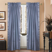 Silver sari rod pocket curtains hung at a window