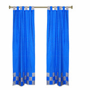 Coral sari tab top curtains hung at a window