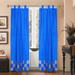 Coral sari tab top curtains hung at a window
