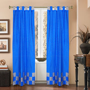 Coral sari tab top curtains hung at a window