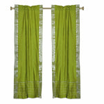 Olive green sari rod pocket curtains hung at a window