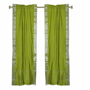 Olive green sari rod pocket curtains hung at a window