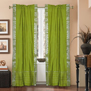 Olive green sari rod pocket curtains hung at a window