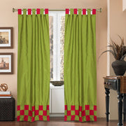 Olive green sari tab top curtains hung at a window