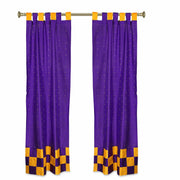 Purple sari tab top curtains hung at a window
