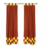 Yellow sari tab top curtains hung at a window