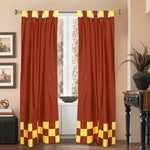 Yellow sari tab top curtains hung at a window