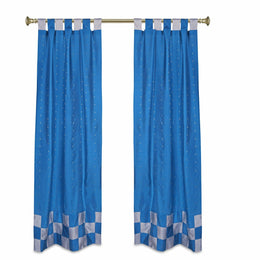 Turquoise sari tab top curtains hung at a window