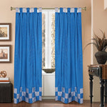 Turquoise sari tab top curtains hung at a window