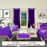 Purple sari tab top curtains hung at a window