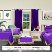 Purple sari tab top curtains hung at a window