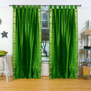 Forest green sari tab top curtains hung at a window