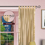 Golden sari tab top curtains hung at a window