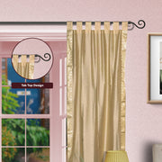 Golden sari tab top curtains hung at a window