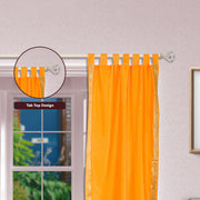 Mustard sari tab top curtains hung at a window