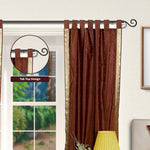 Brown sari tab top curtains hung at a window