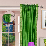 Forest green sari rod pocket curtains hung at a window