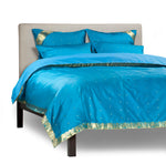 Turquoise sari duvet cover set made up on a bed