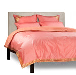 Pink sari duvet cover set made up on a bed
