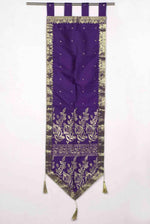 Purple sari wall hanging displayed on a wall