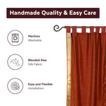 Rust sari tab top curtains hung at a window