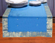 Turquoise silk table runner running down a dining table