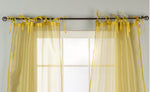 Sheer tissue tie top curtains hung at a window