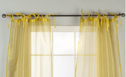 Sheer tissue tie top curtains hung at a window
