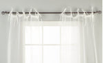 Sheer tissue tie top curtains hung at a window