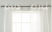 Sheer tissue tie top curtains hung at a window