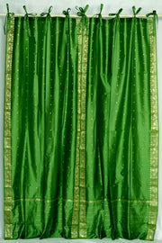 Forest green sari tie top curtains hung at a window