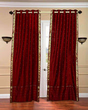 Maroon sari grommet top curtains hung at a window