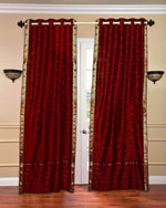 Maroon sari grommet top curtains hung at a window