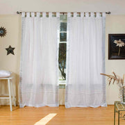 Silver sari tab top curtains hung at a window