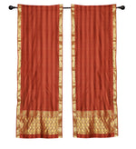Rust sari rod pocket curtains hung at a window