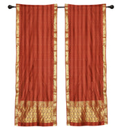 Rust sari rod pocket curtains hung at a window