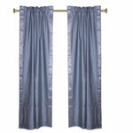 Silver sari rod pocket curtains hung at a window
