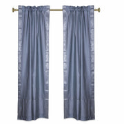 Silver sari rod pocket curtains hung at a window