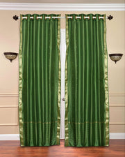 Forest green sari grommet top curtains hung at a window