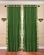 Forest green sari grommet top curtains hung at a window