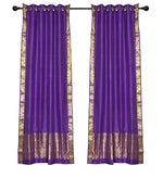 Purple sari ring top curtains hung at a window